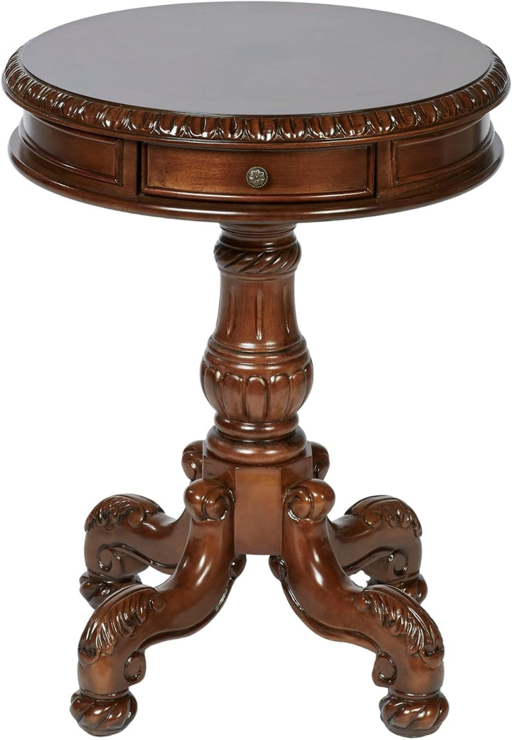 A round wooden accent table with a carved pedestal base and three claw-style legs, featuring a single drawer on the front of the tabletop.