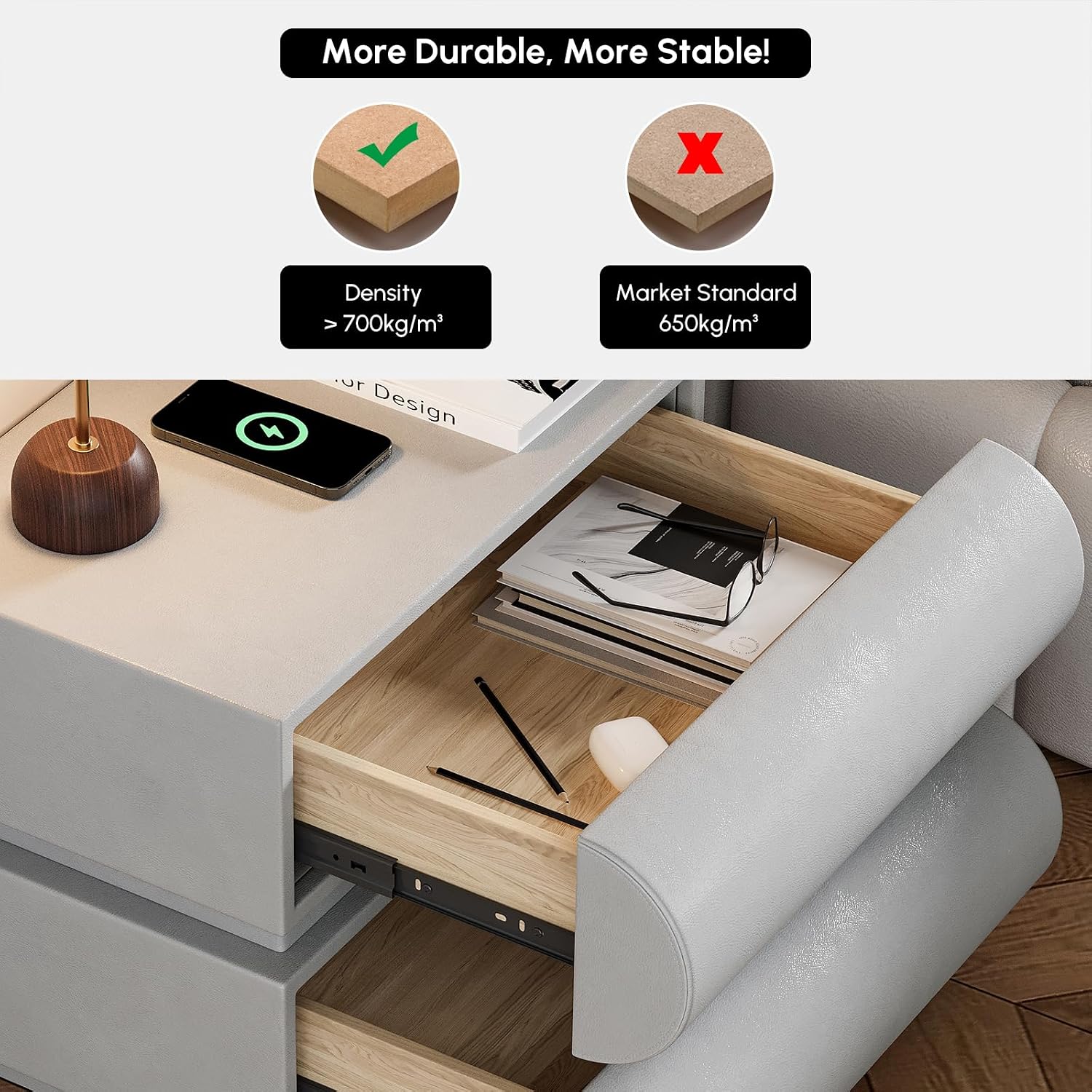A light gray upholstered drawer with a wood-look interior, shown open on a bed or sofa. The top portion includes marketing text and comparison icons stating density is greater than 700kg/m³ and market standard is 650kg/m³.