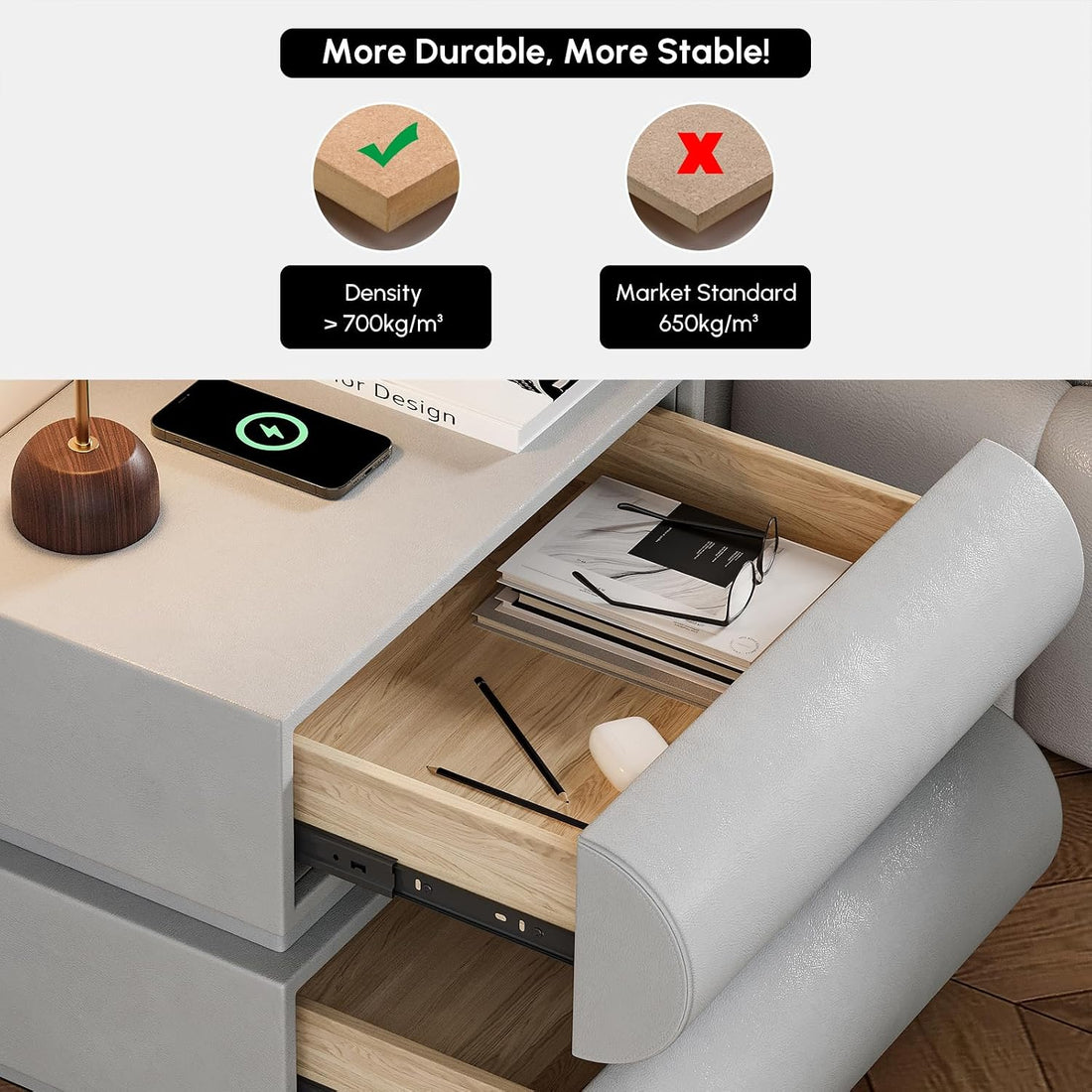 A light gray upholstered drawer with a wood-look interior, shown open on a bed or sofa. The top portion includes marketing text and comparison icons stating density is greater than 700kg/m³ and market standard is 650kg/m³.