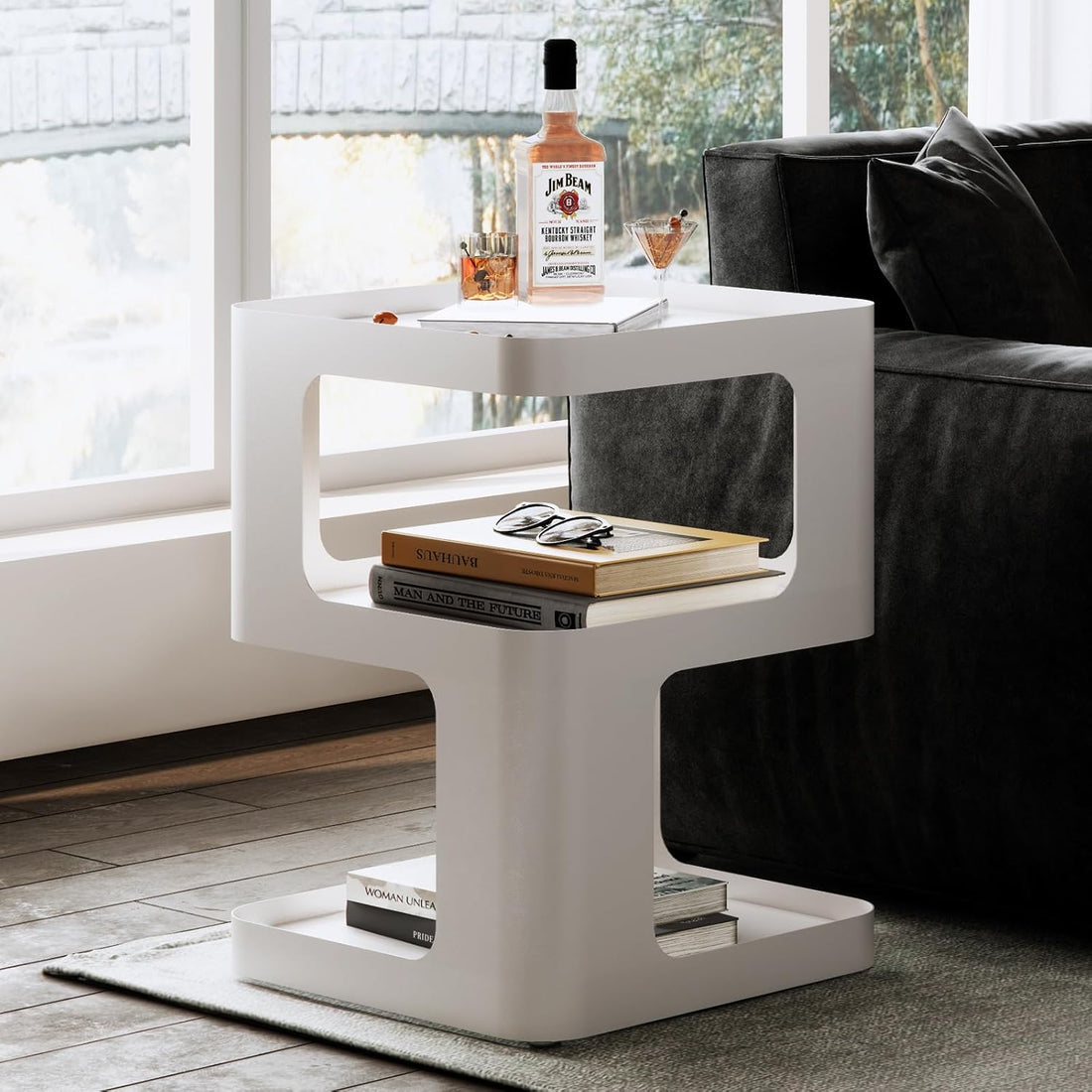 White side table with books and a bottle in a living room setting