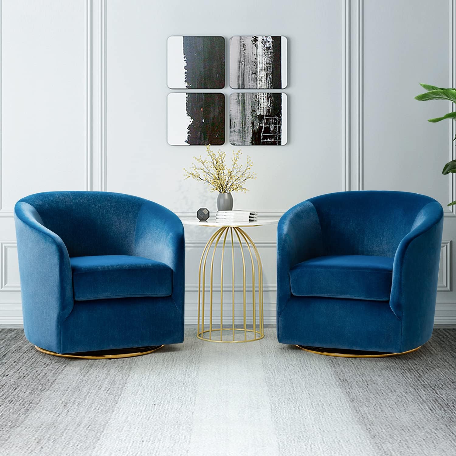 Two blue armchairs in a modern living room with abstract art on the wall.