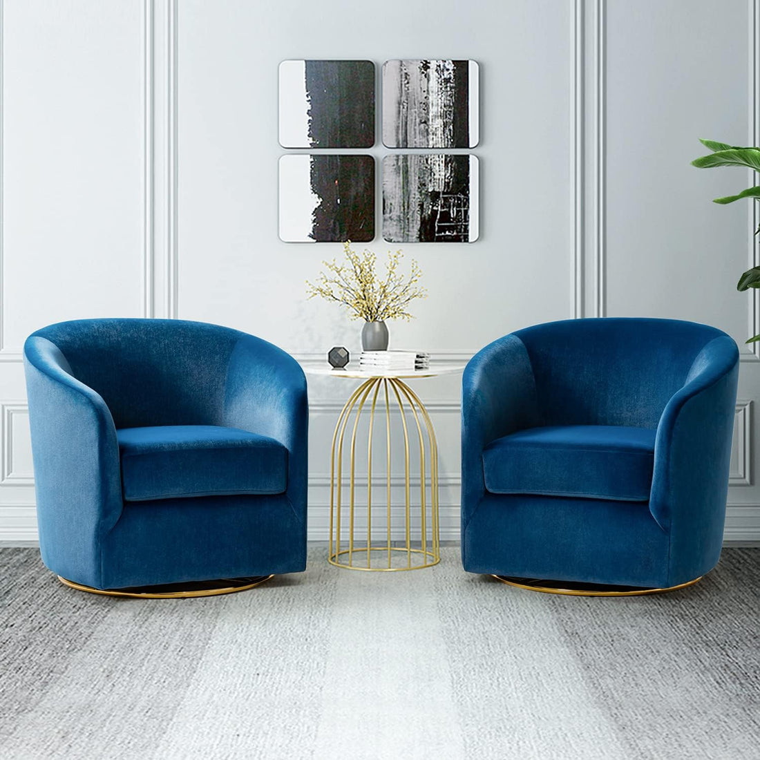 Two blue armchairs in a modern living room with abstract art on the wall.