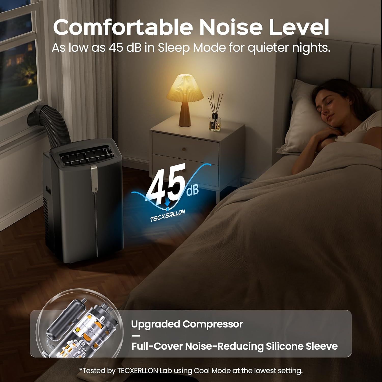 A portable window air conditioner with a dark gray body and flexible hose is shown in a bedroom setting next to a bed where a woman is sleeping. Text overlays highlight its 'Comfortable Noise Level' of 45 dB sleep mode, along with features like an upgraded compressor and a full-cover noise-reducing silicone sleeve.