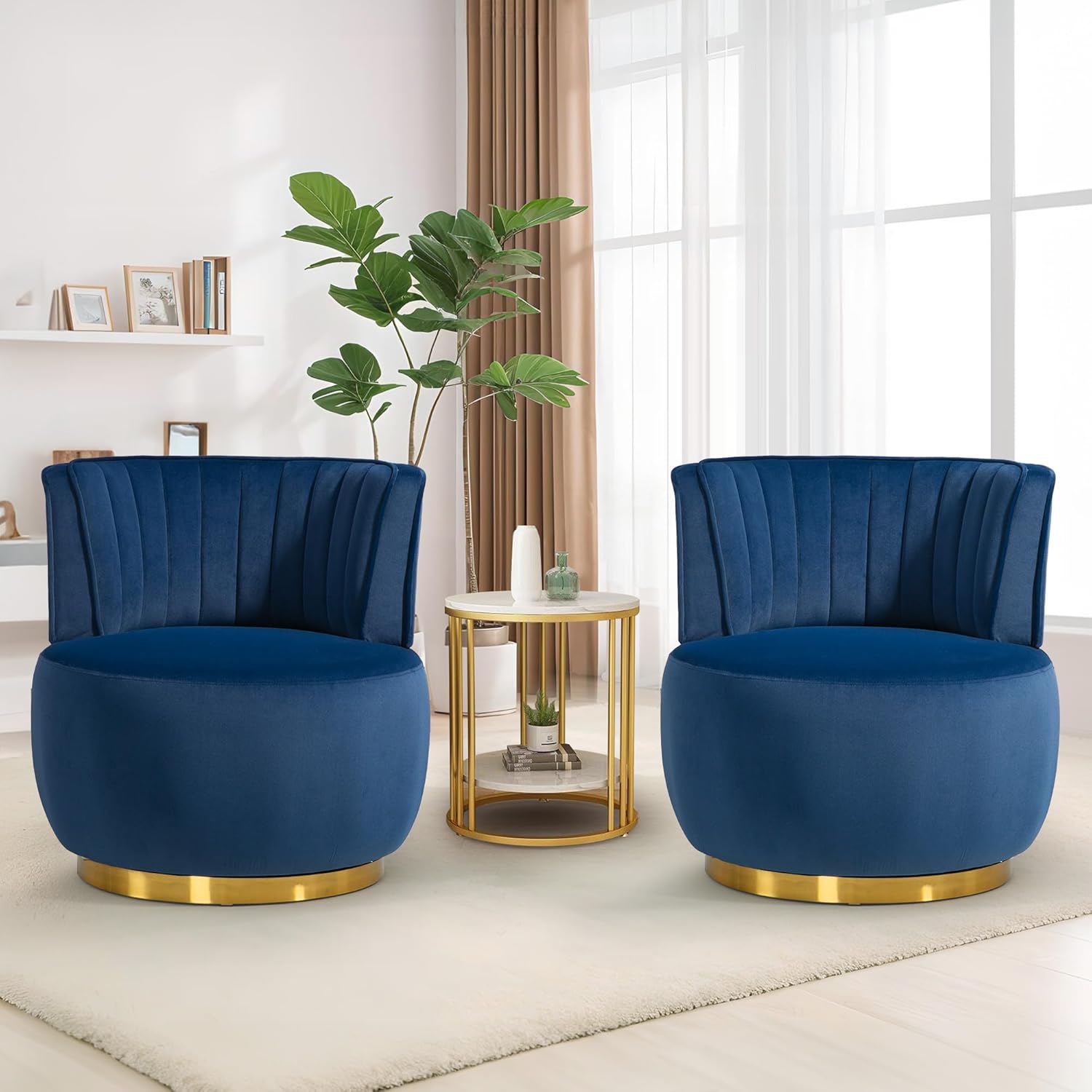 Two blue velvet chairs with gold bases in a living room setting.