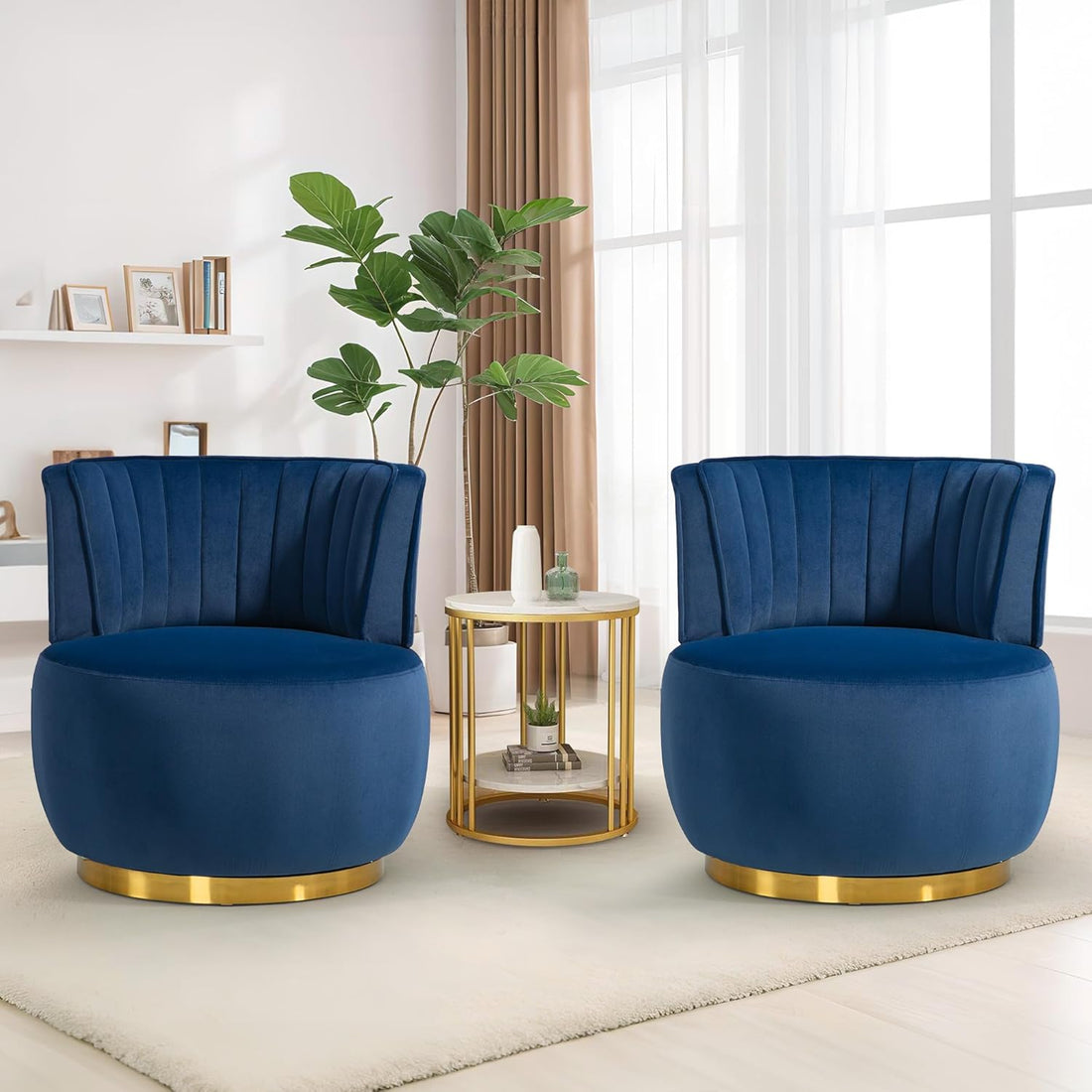 Two blue velvet chairs with gold bases in a living room setting.