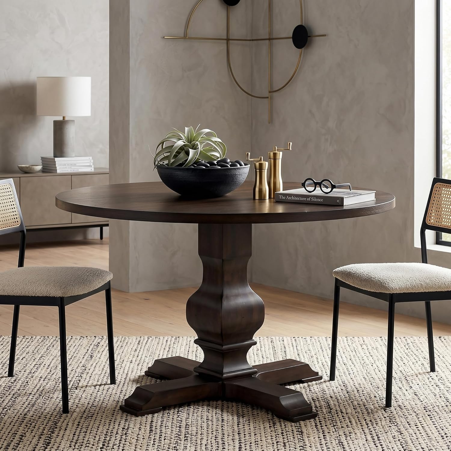 Round wooden dining table with chairs in a room setting