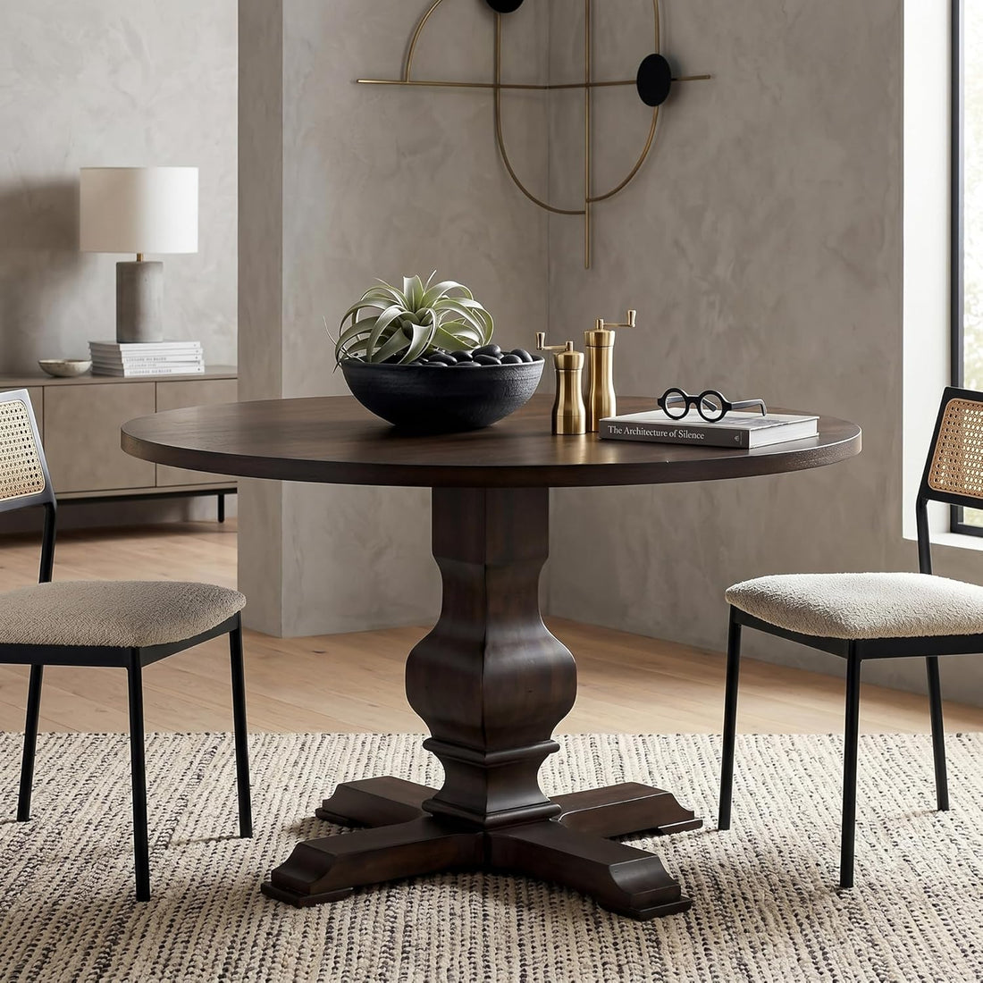 Round wooden dining table with chairs in a room setting