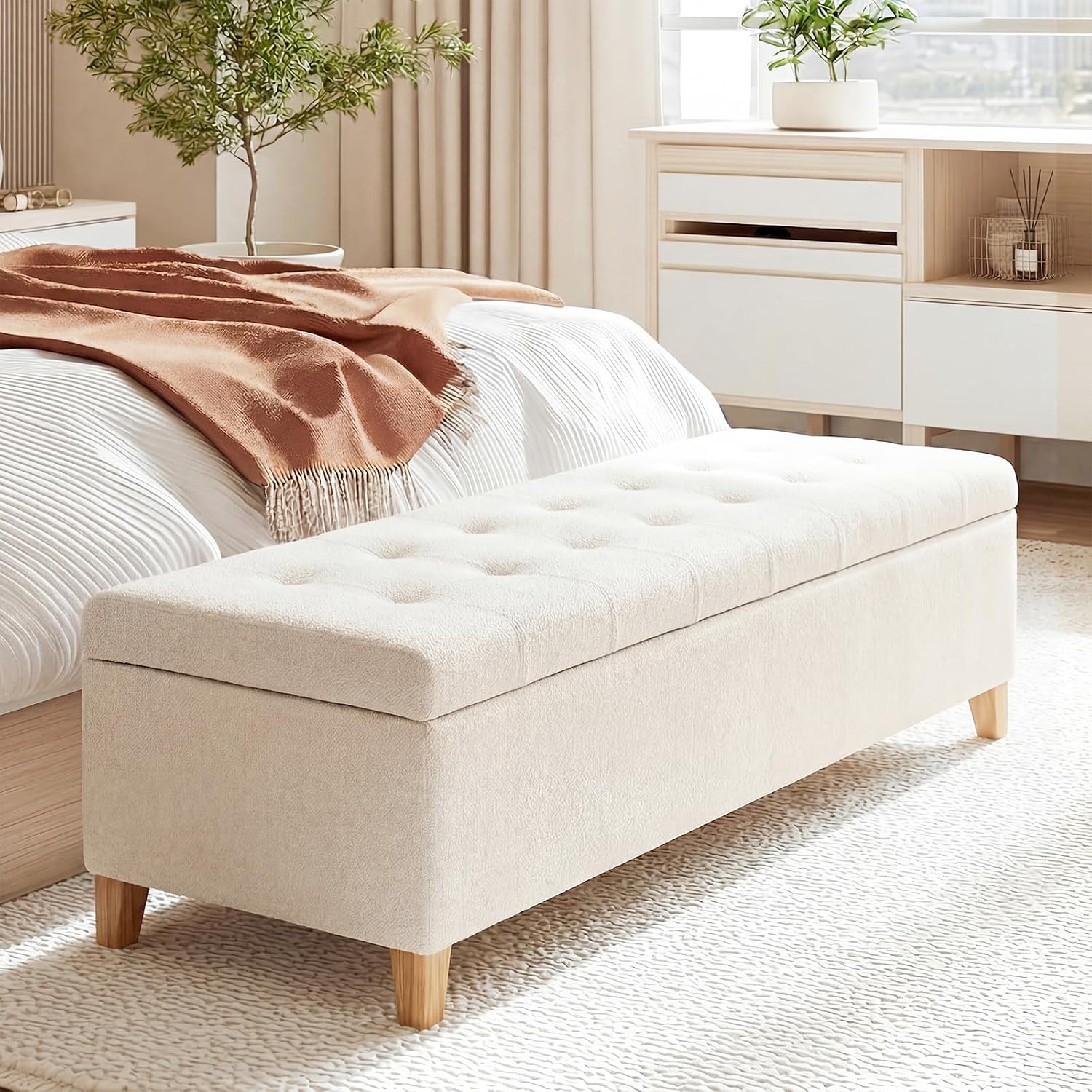 Beige ottoman with wooden legs in a living room setting