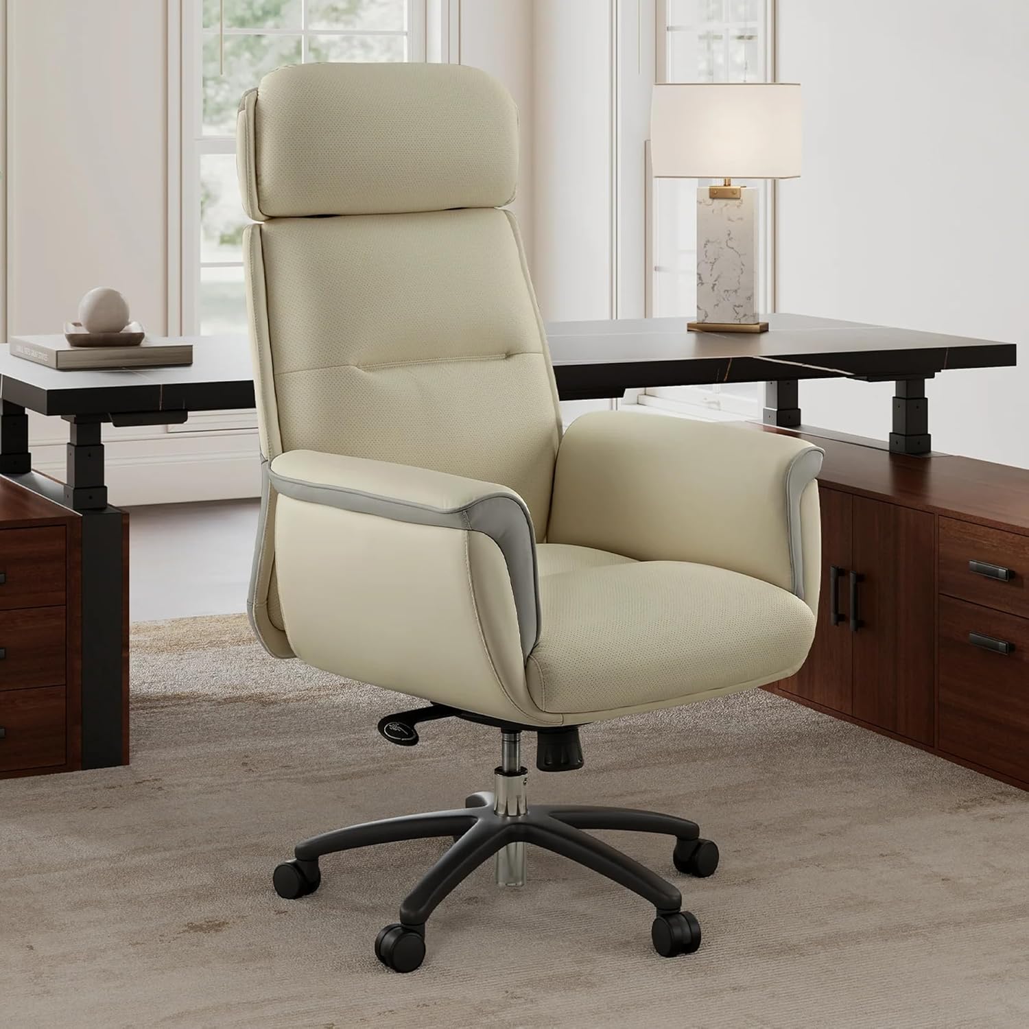 Beige office chair in a home office setting with a desk and lamp.