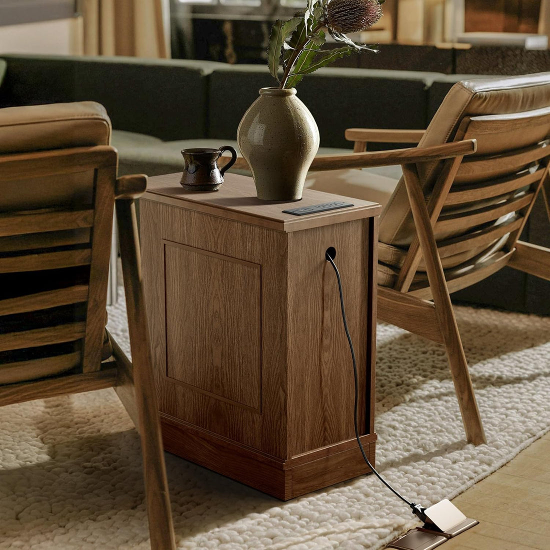 Wooden side table with a vase and mug in a living room setting