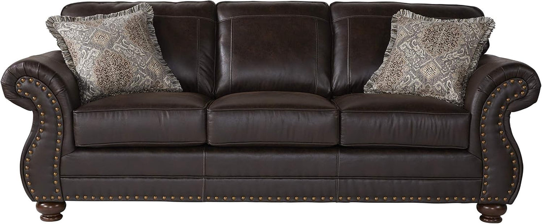 Brown leather sofa with decorative pillows on a white background