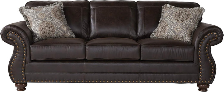 Brown leather sofa with decorative pillows on a white background