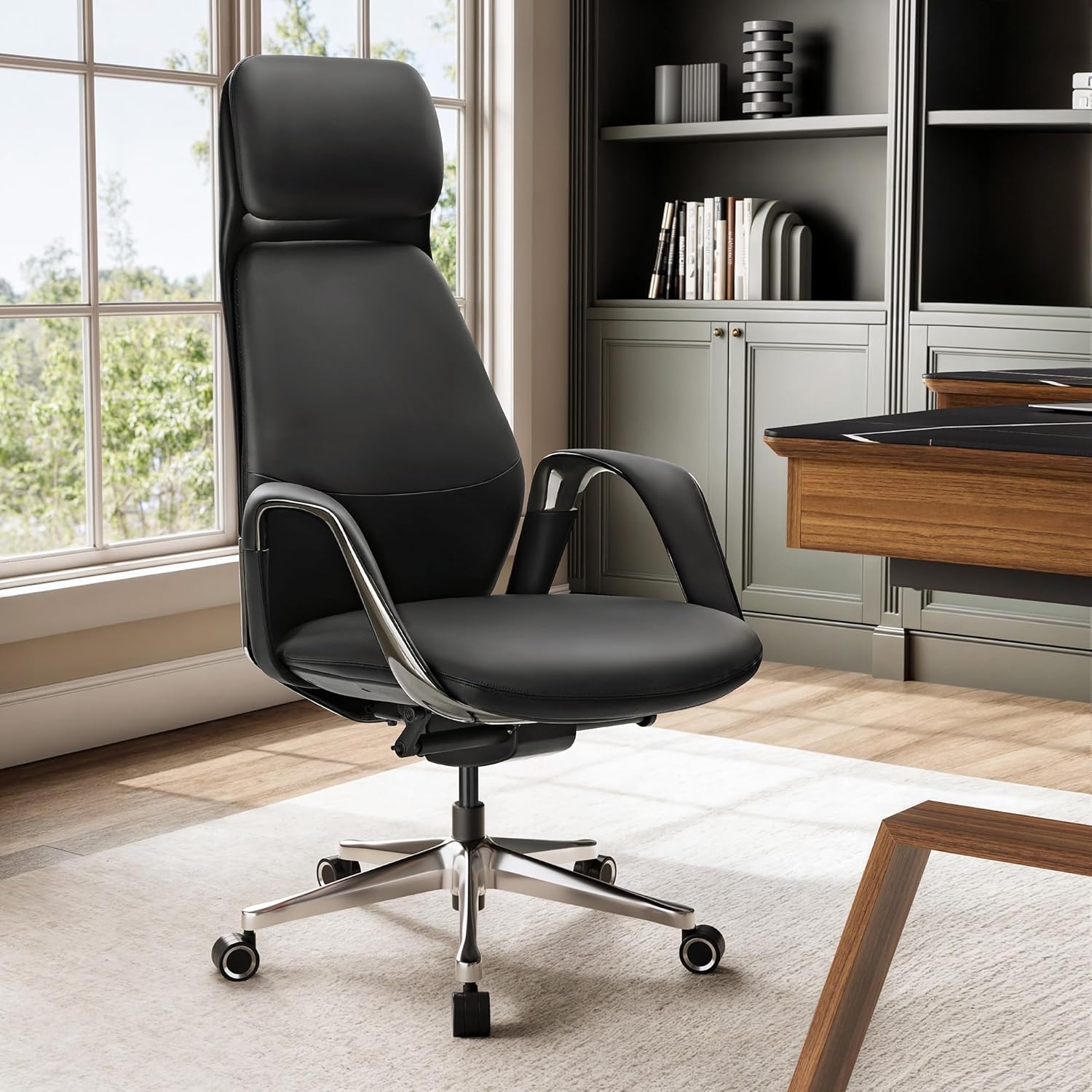 Black office chair in a modern office setting with a desk and bookshelf.