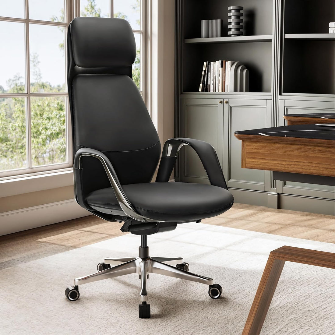 Black office chair in a modern office setting with a desk and bookshelf.