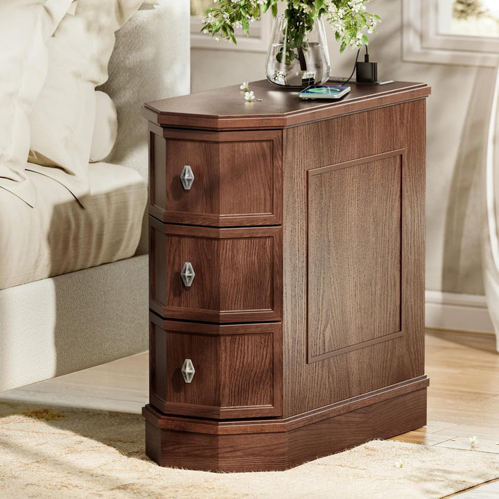 Wooden nightstand with three drawers in a bedroom setting