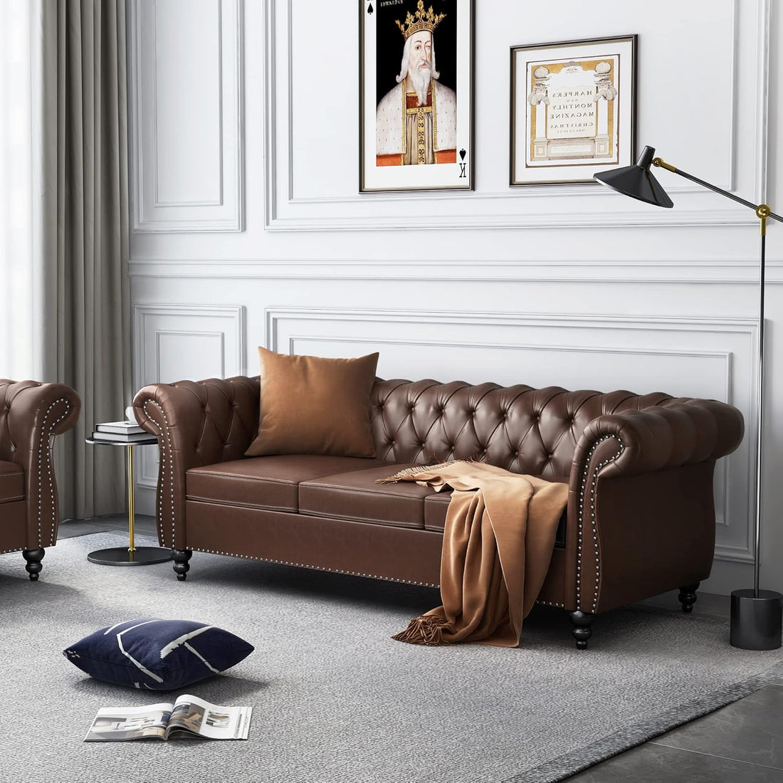 Brown leather sofa in a stylish living room with decorative pillows and a lamp.