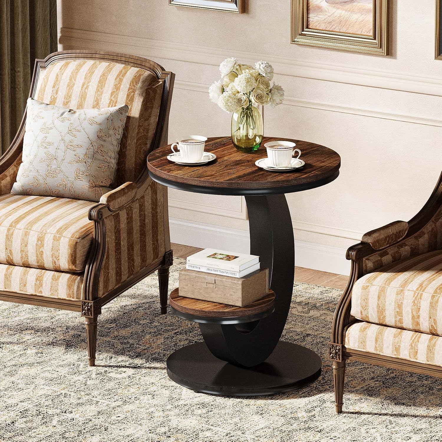 Two ornate armchairs with a small round table in a living room setting.