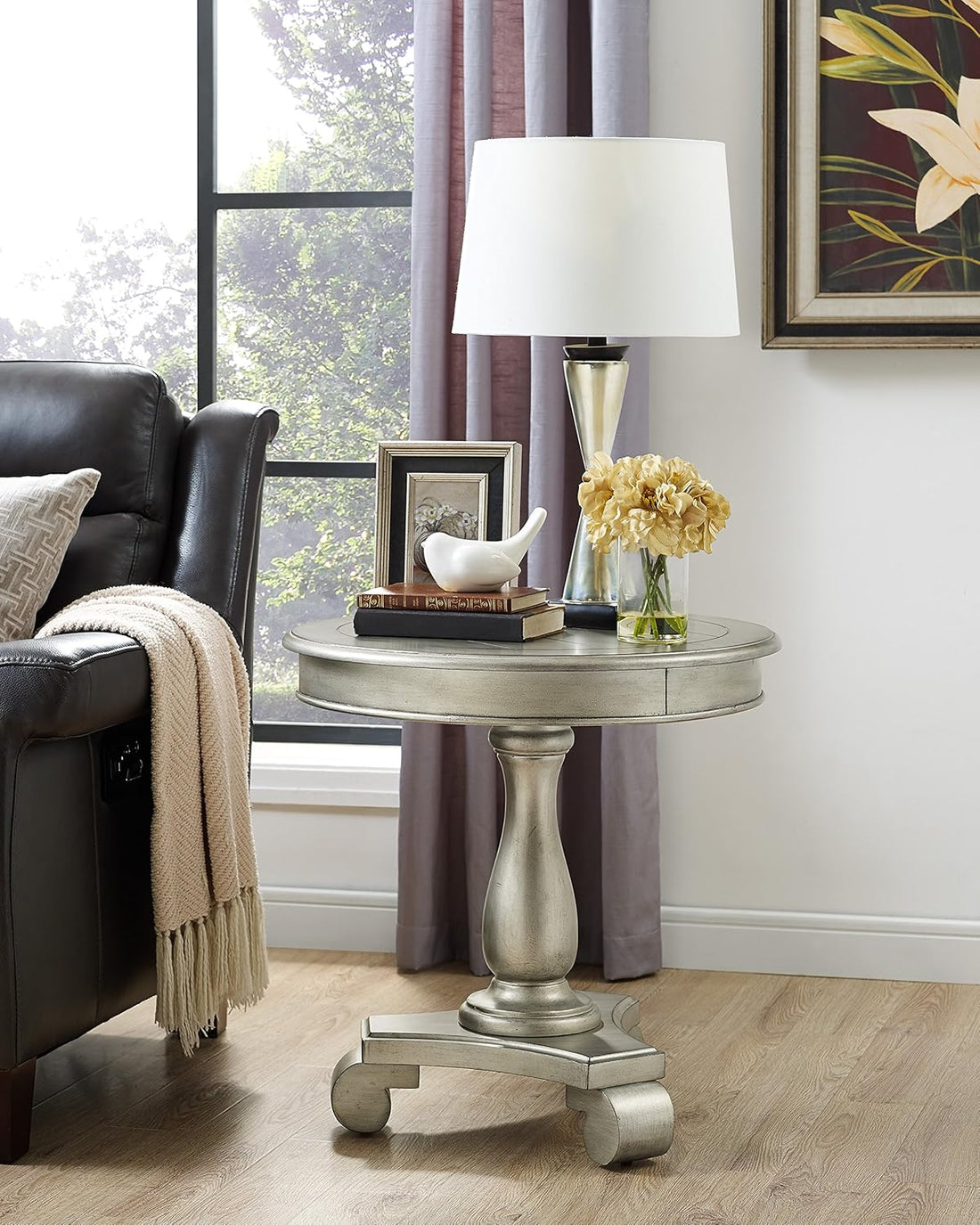 Silver side table with decorative items in a living room setting