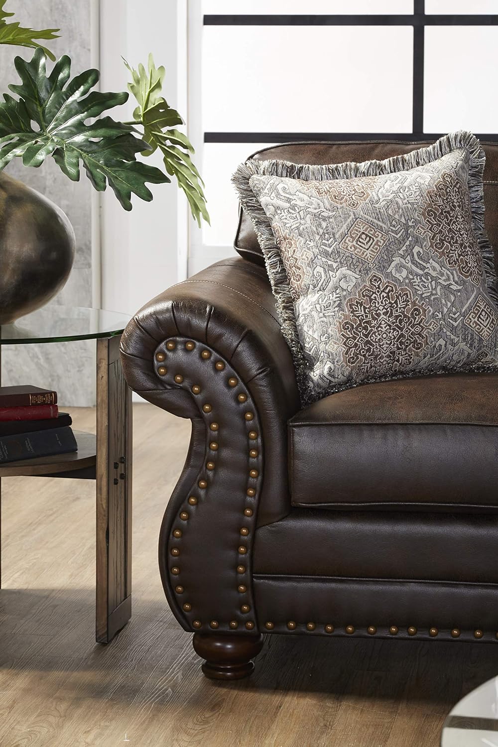 Brown leather sofa with decorative pillow in a living room setting