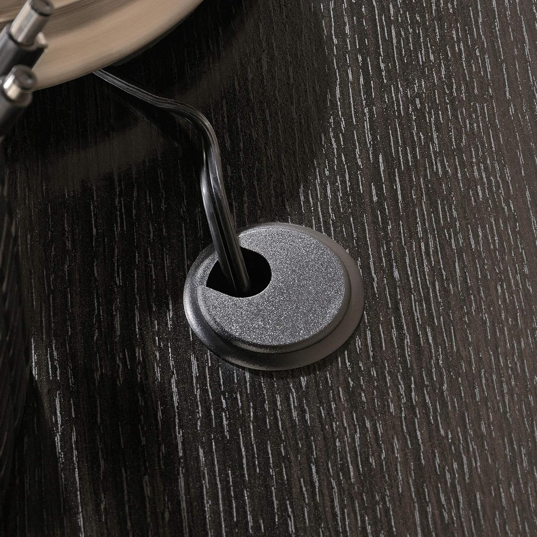 Close-up of a black cable gland on a wooden surface
