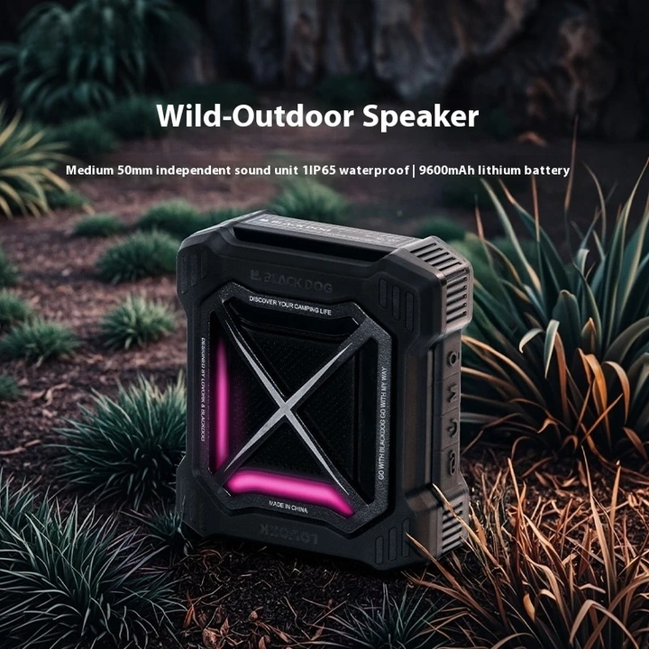 Black outdoor speaker with pink accents in a natural setting