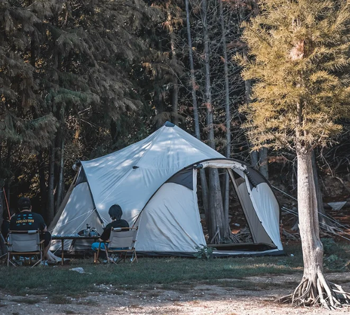 Camping scene with a large tent in a forest