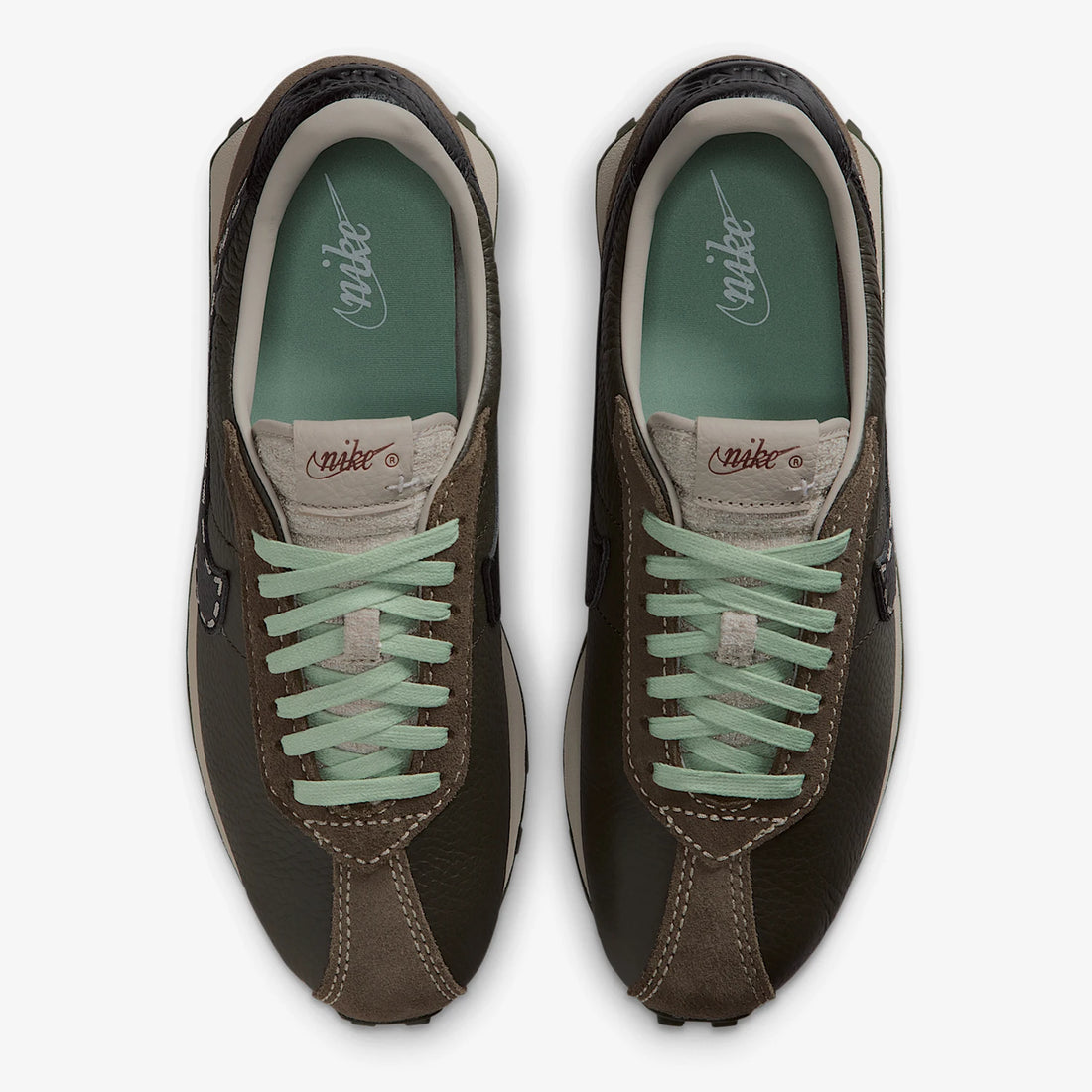 Pair of brown sneakers with green laces on a white background