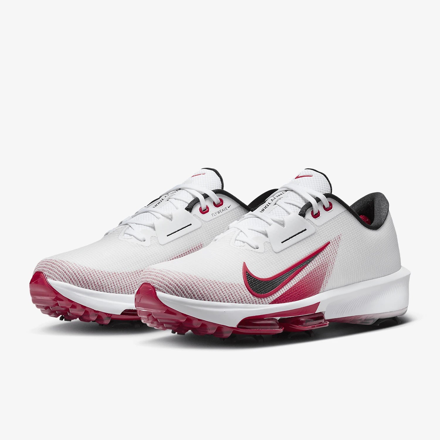 A pair of Nike golf shoes in white with a dark red and green gradient Swoosh, pinkish-red cleats, and black accents, shown on a light gray background.