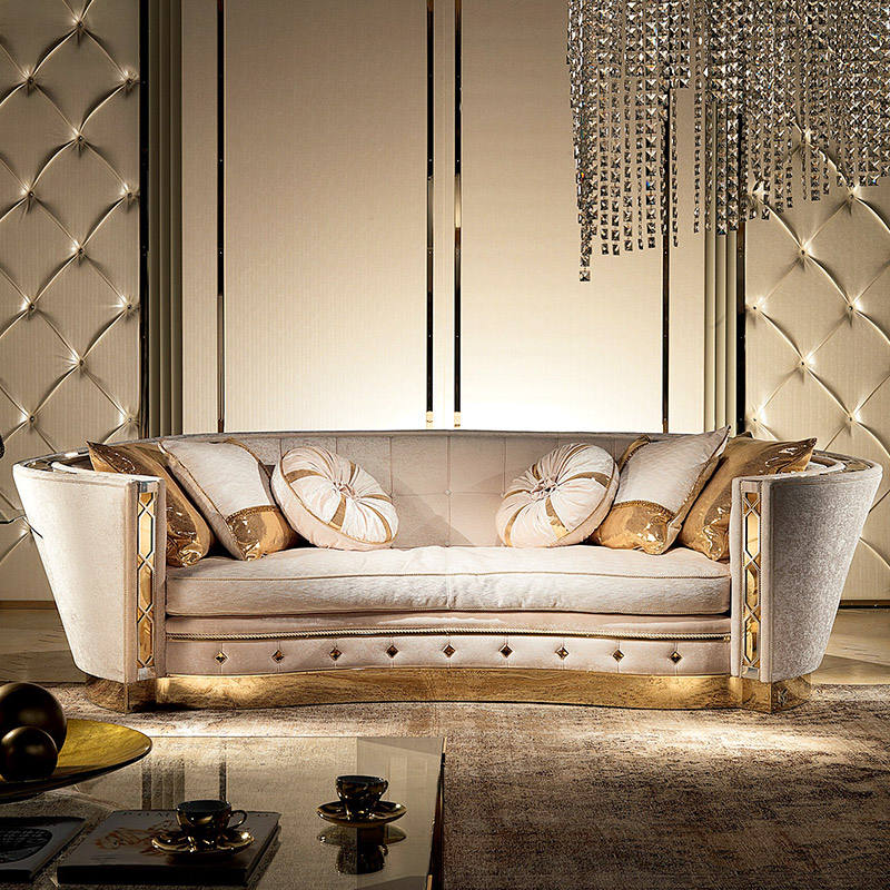 Luxurious living room with a decorative sofa, ornate chandelier, and reflective floor.