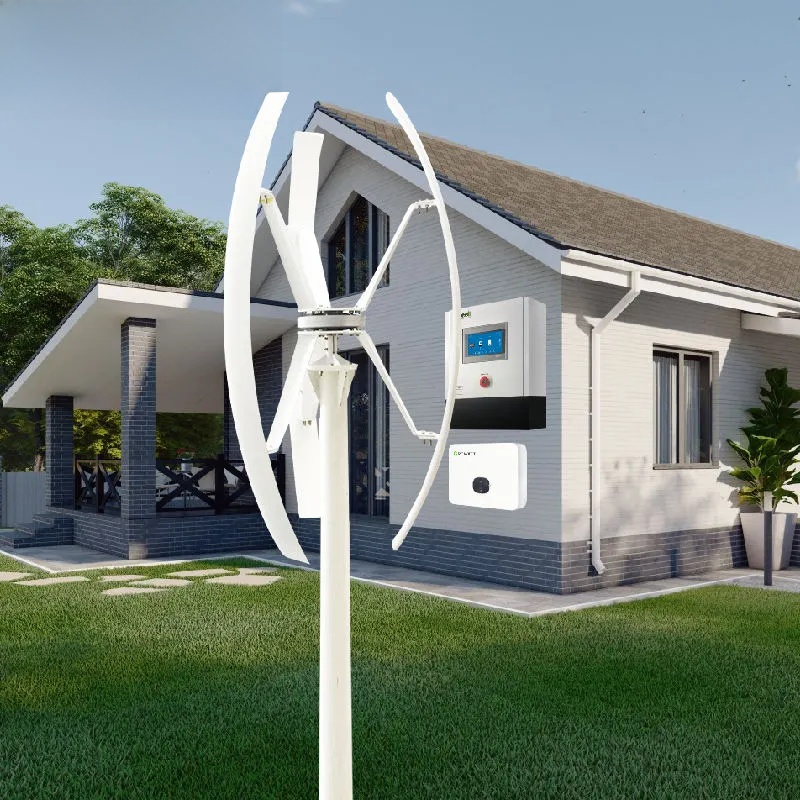 Large wind turbine in front of a house with green grass and trees.