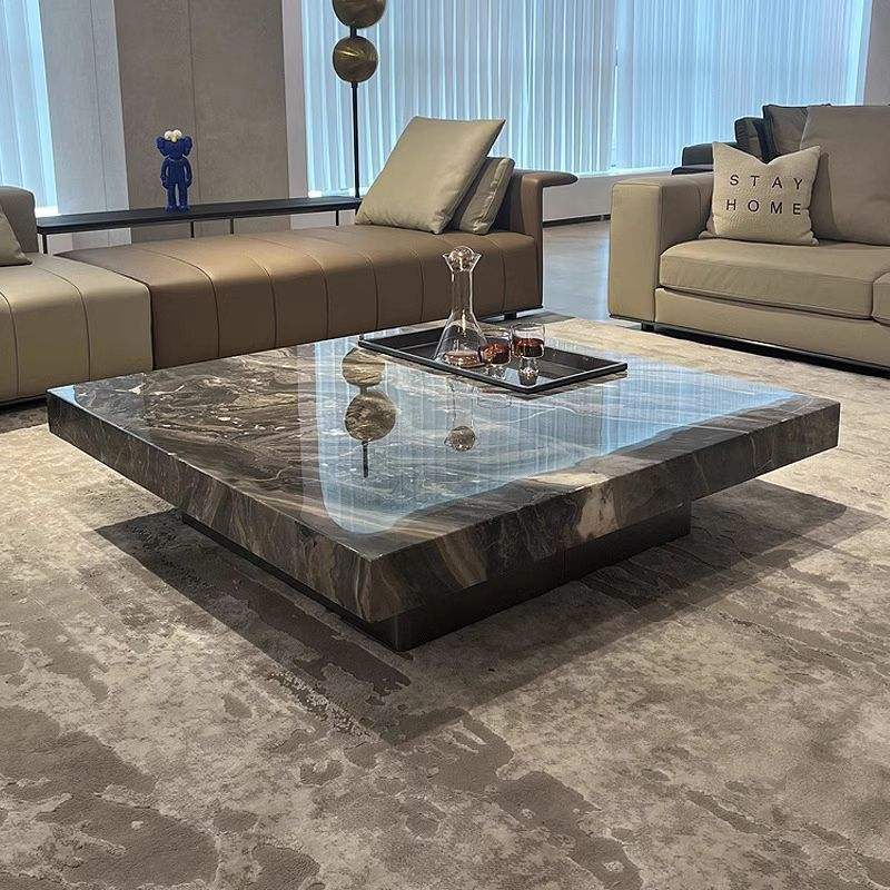Modern living room with a marble coffee table and stylish furniture.