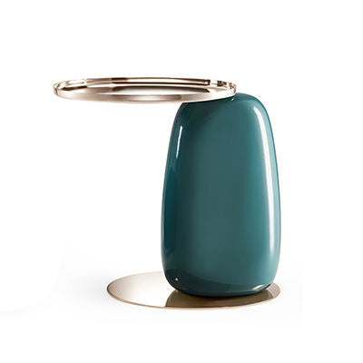 A modern sculptural side table featuring a glossy dark teal ceramic base and a polished gold-finished circular metal top and circular foot ring, set against a plain white background.