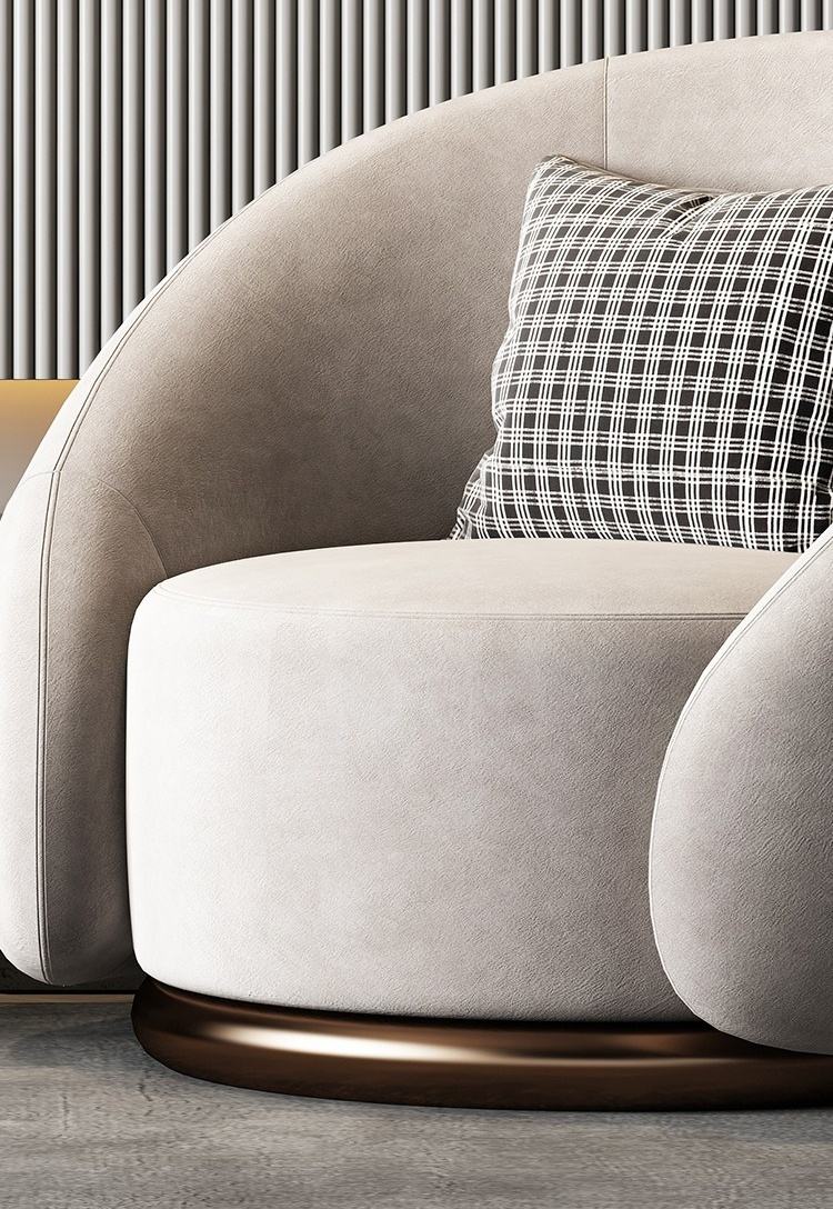 Gray sofa with a plaid pillow against a neutral wall.