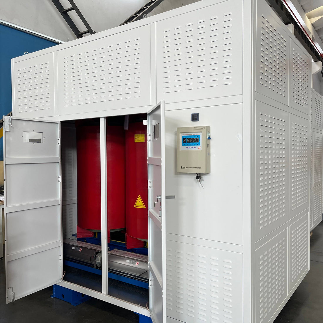 Large industrial cabinet with red interior and digital display on a gray floor.