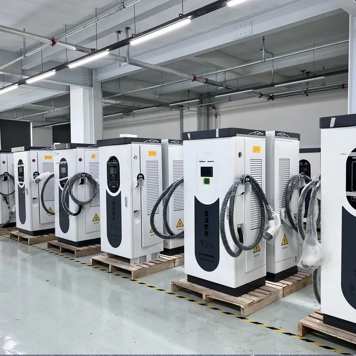 Row of electric vehicle charging stations in a warehouse setting
