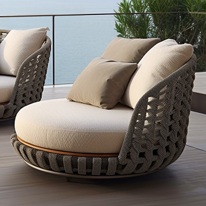 Modern outdoor chair with beige cushions on a patio with water view