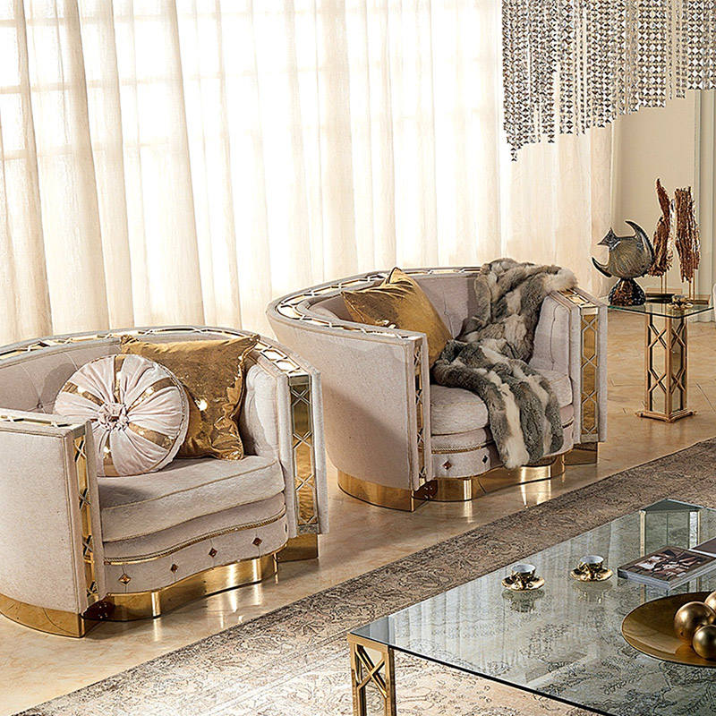 Luxury living room with beige armchairs, decorative pillows, and a glass coffee table.