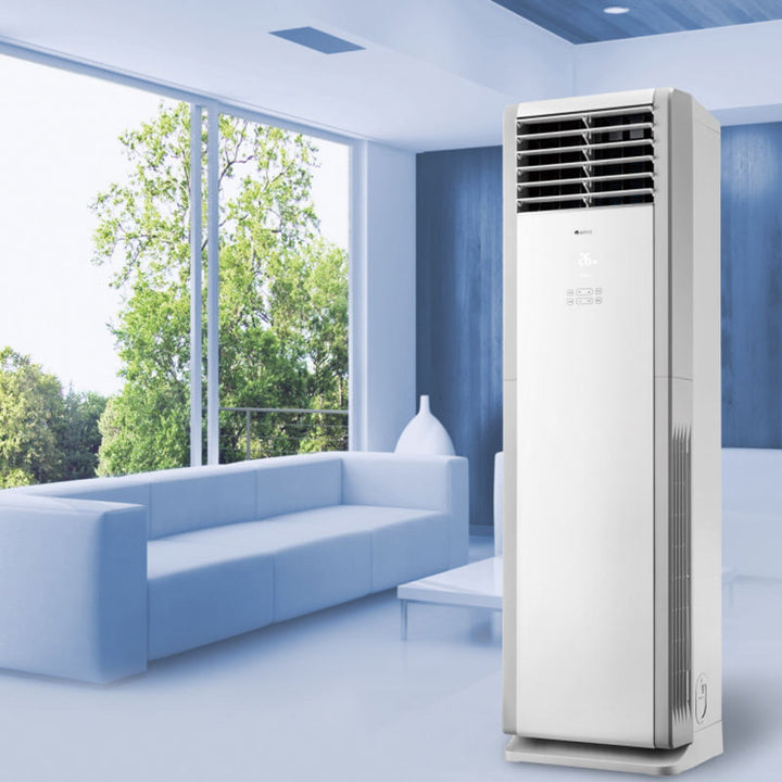Tall white air conditioner in a modern living room with large windows.