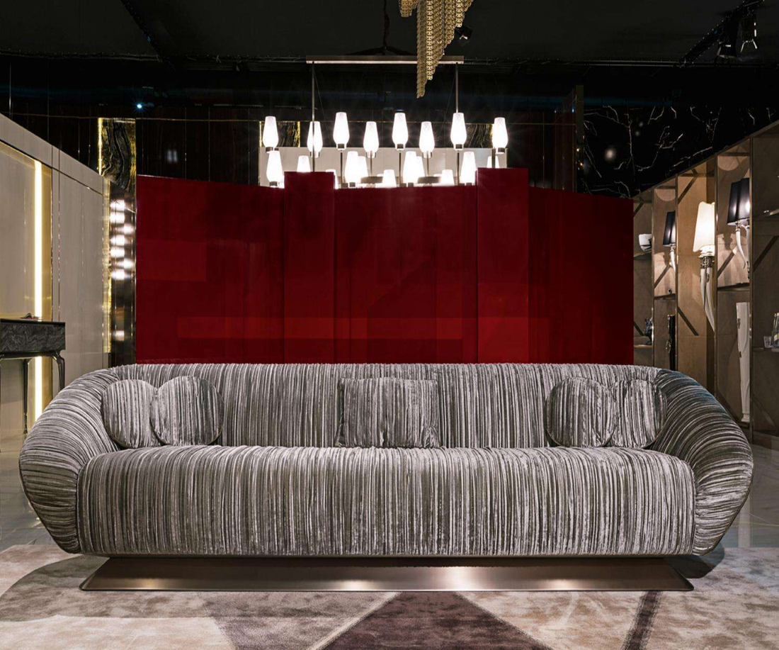 Gray sofa in a stylish room with red accent wall and modern decor