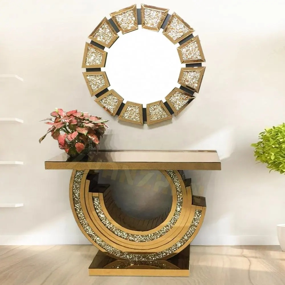 Decorative console table with round mirror and floral arrangement against a white wall.