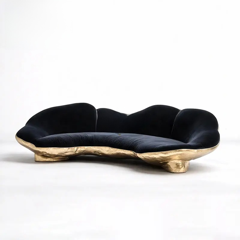 Modern black sofa with gold base on a white background