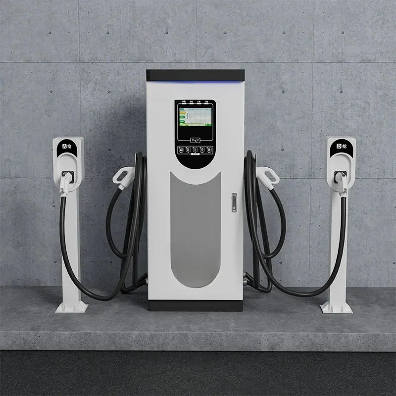 Electric vehicle charging station with three charging points against a gray concrete wall.