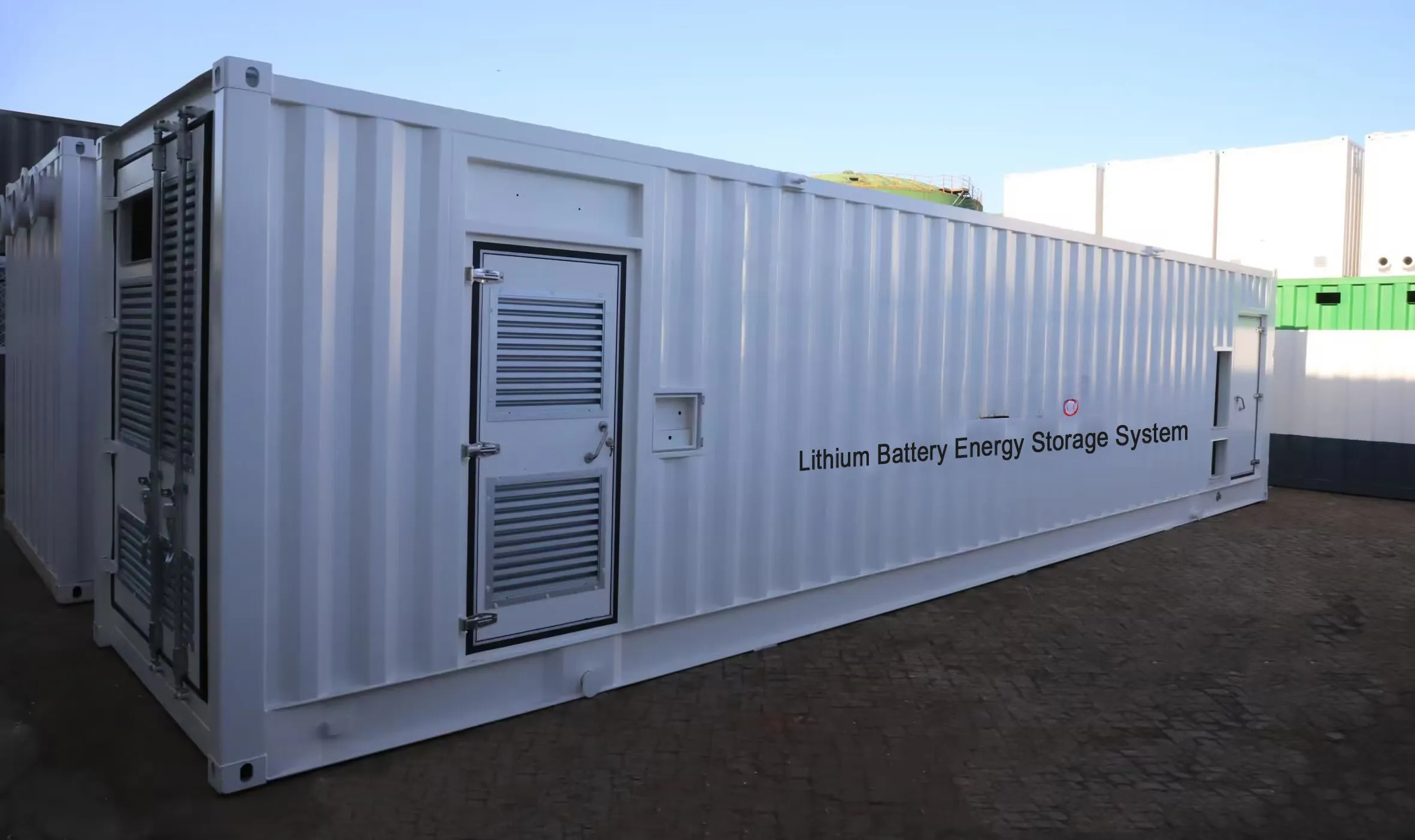 Lithium battery energy storage system container with visible branding on a clear day.