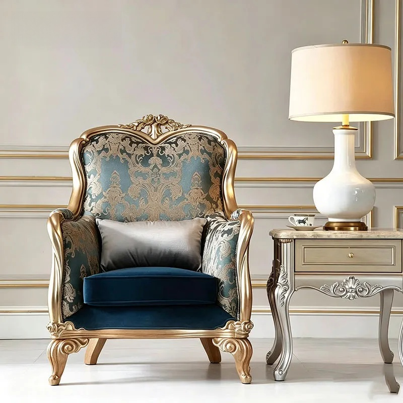 Luxurious armchair with gold frame and blue cushion in a stylish room.
