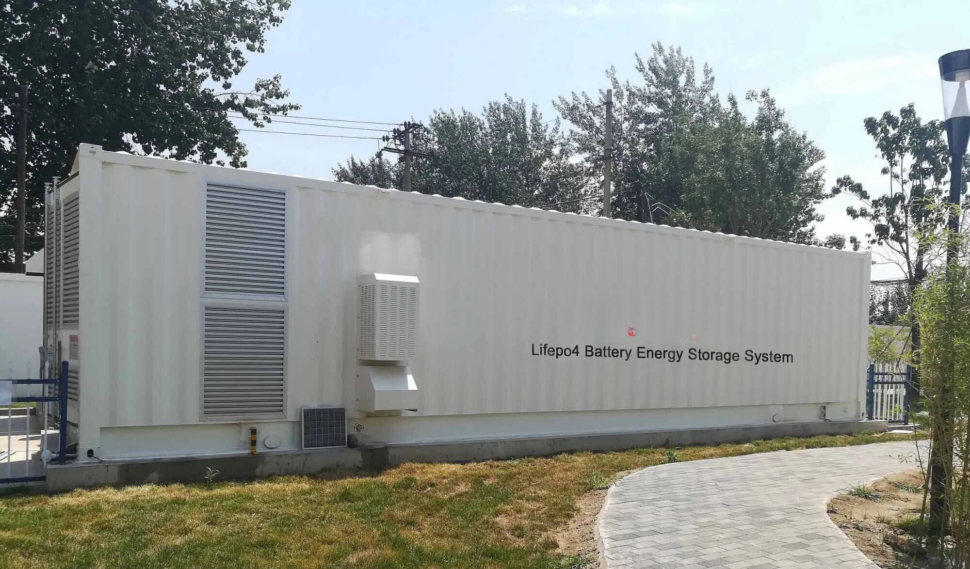 Large battery energy storage system with 'Lifepo4 Battery Energy Storage System' branding outdoors.