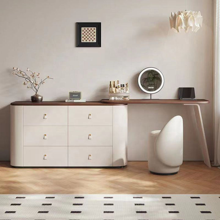 Modern interior with a white dresser, wooden sideboard, and decorative items.