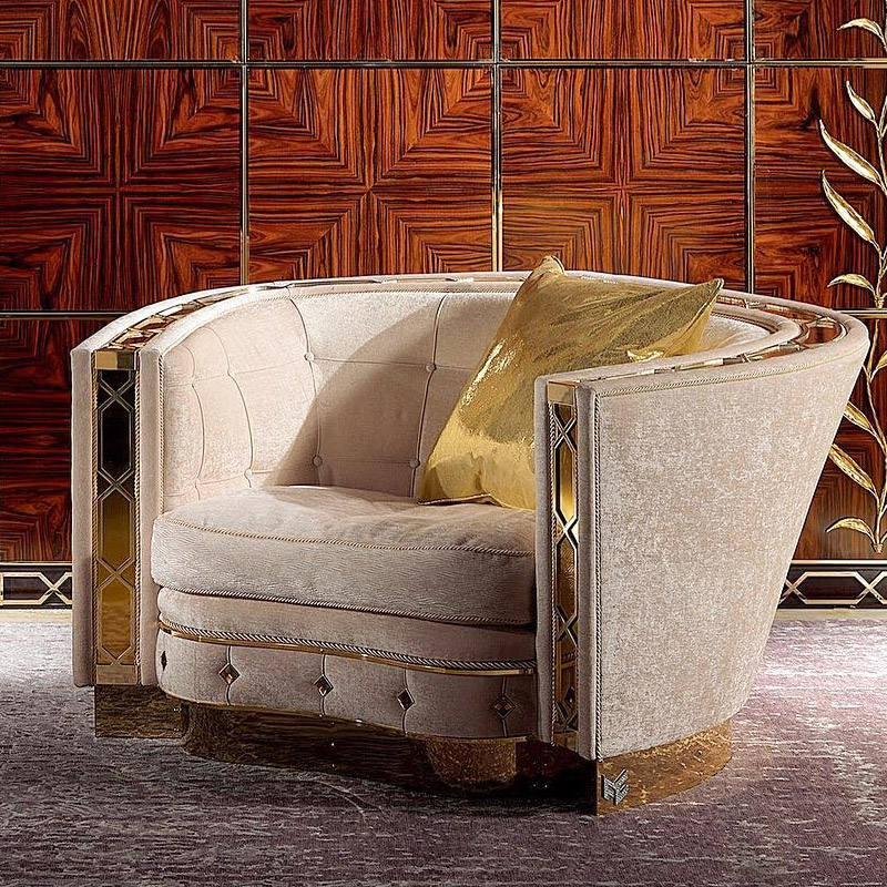 Decorative armchair with a gold pillow against a patterned wall.