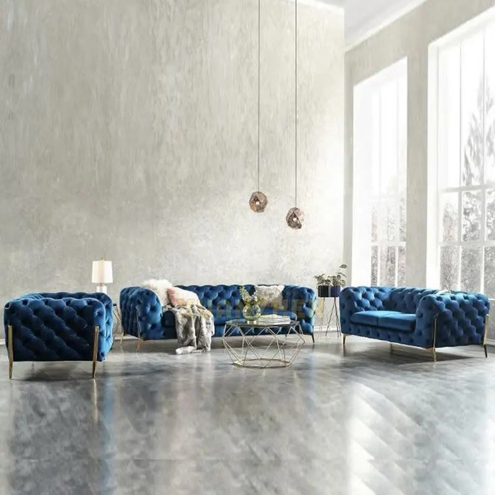 Modern living room with blue tufted sofas and a glass coffee table.