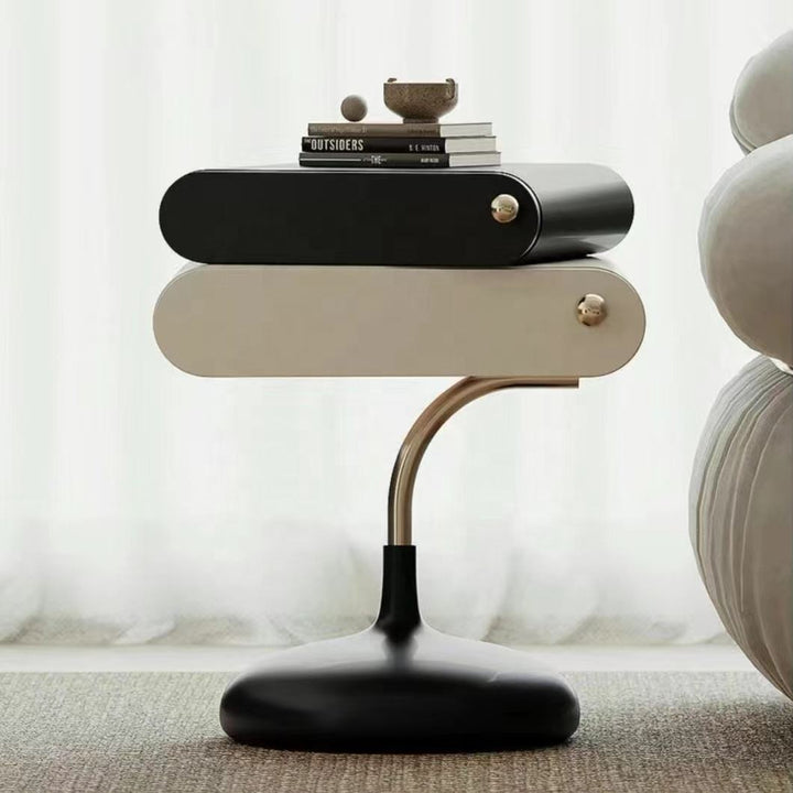 Modern side table with a black and gold design, featuring books on top.