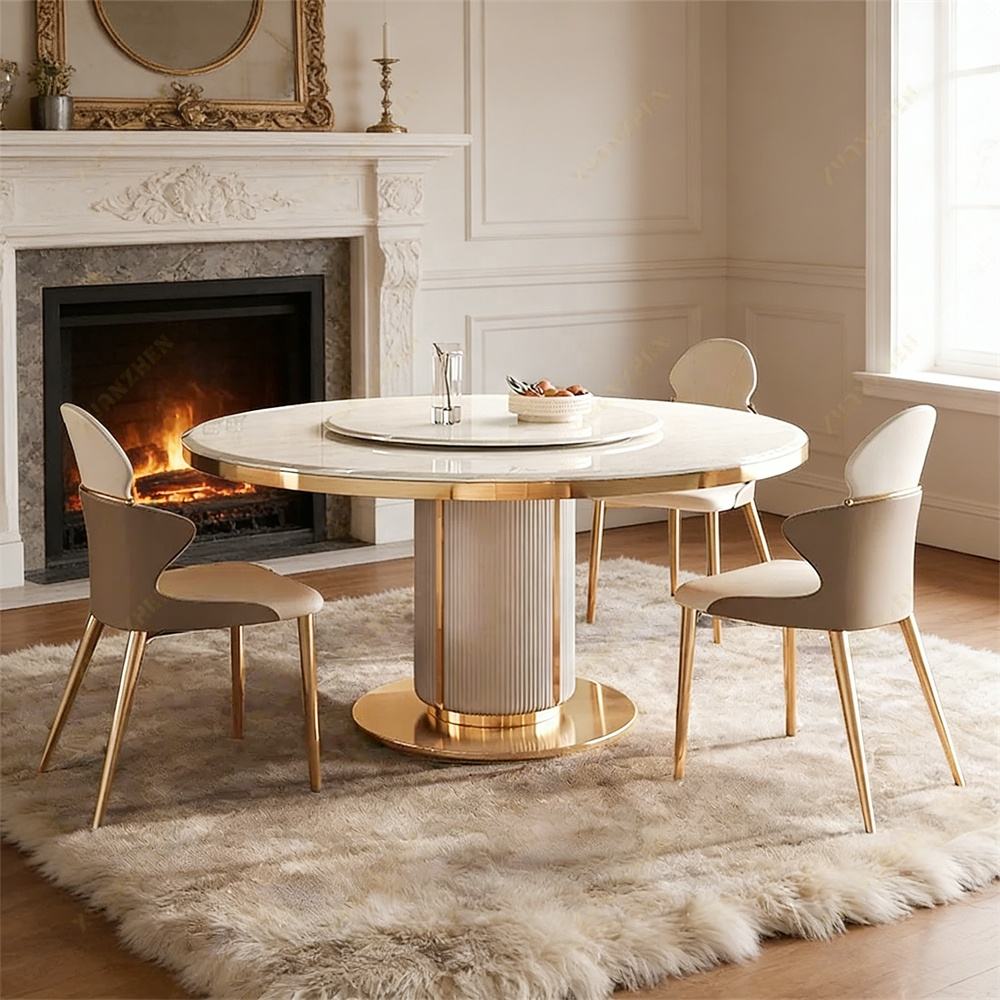 Dining room with a round table and chairs in front of a fireplace.